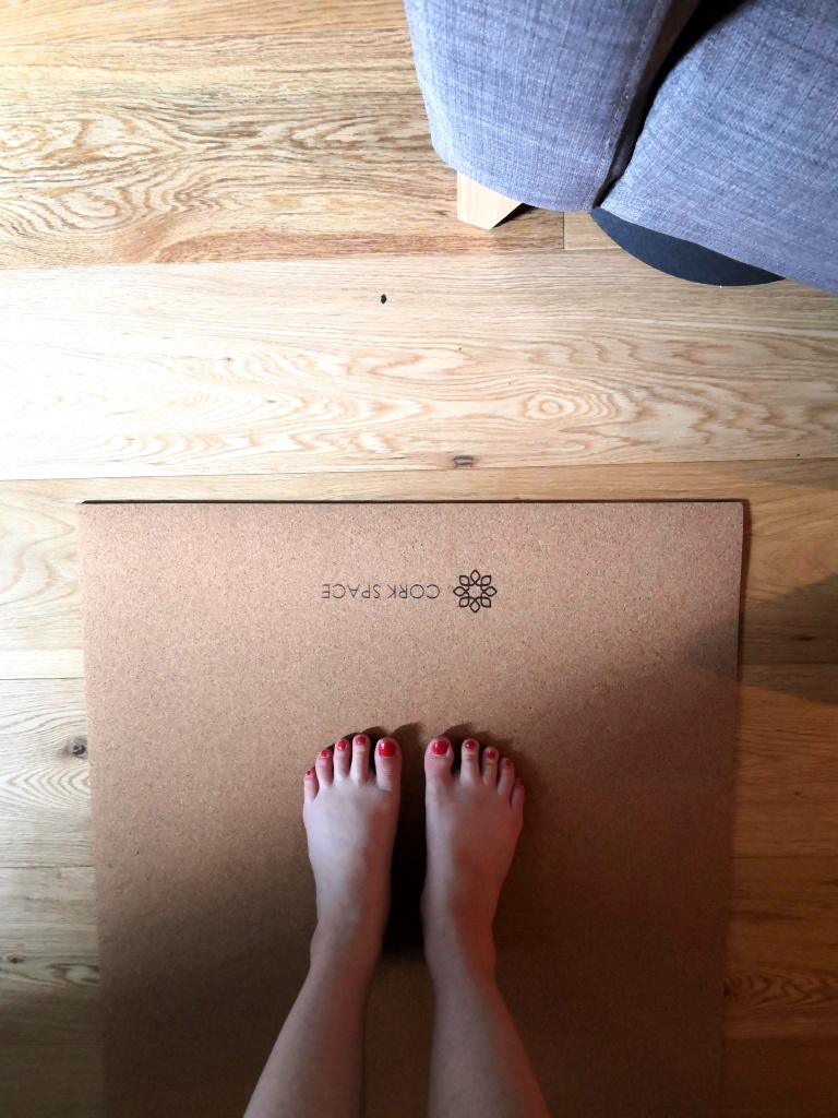 A picture of the new Cork Space yoga mat and my bare feet on it.